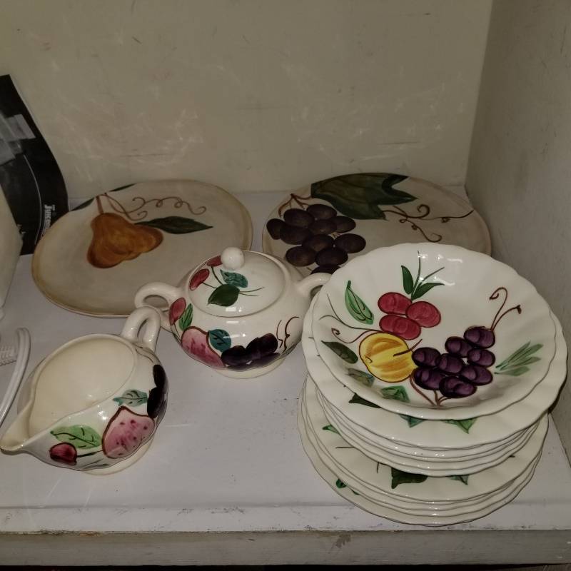 lot 11600 image: Tabletops Ceramica Classica Venetian 2 Salad Plates 8 Pear and Grapes, A partial set of hand painted dishes that include a sugar bowl and creamer, two collectiable tea pots and a silver plated wire basket.