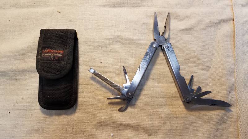 lot 9179 image: Multi-Tool - Coleman on the tool, Leatherman on the Sheath.  Looks like it fits, maybe Leatherman made it for Coleman  Dont know, but its got a good selection of tools